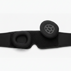 Black headband with two round cushions on a white background